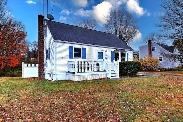 view of front facade featuring a front yard and a deck