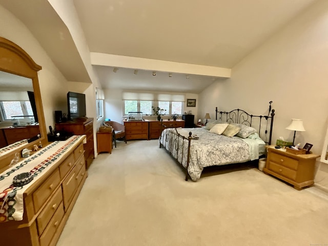 carpeted bedroom with lofted ceiling