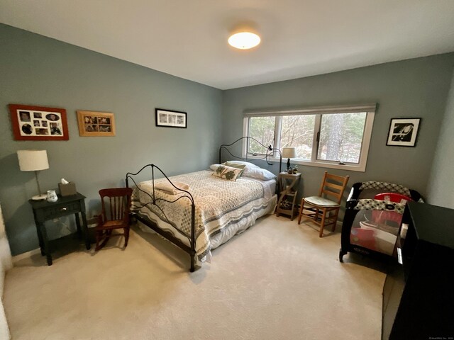 bedroom featuring light carpet