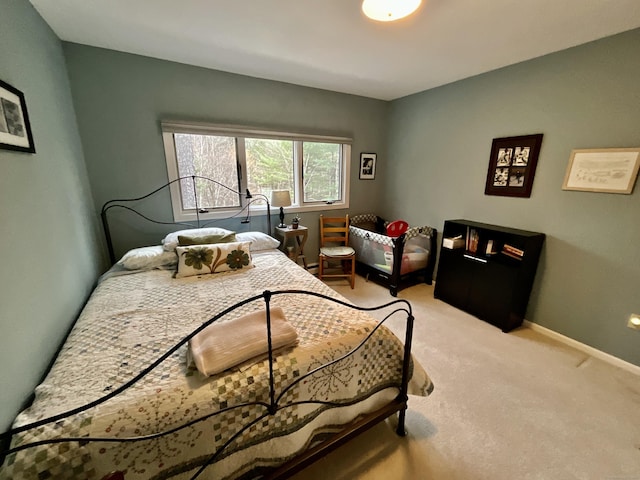 bedroom featuring light carpet