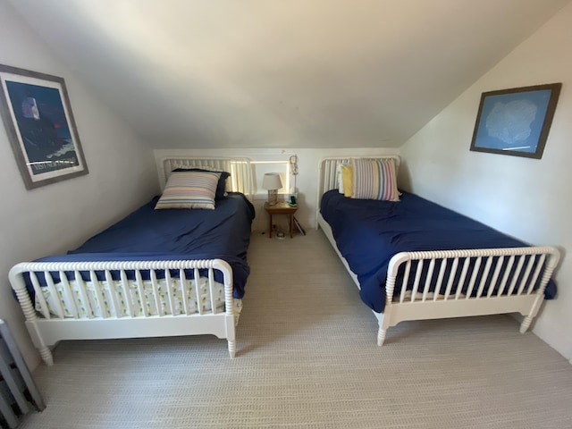 bedroom featuring carpet flooring and vaulted ceiling