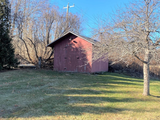 view of outbuilding with a yard