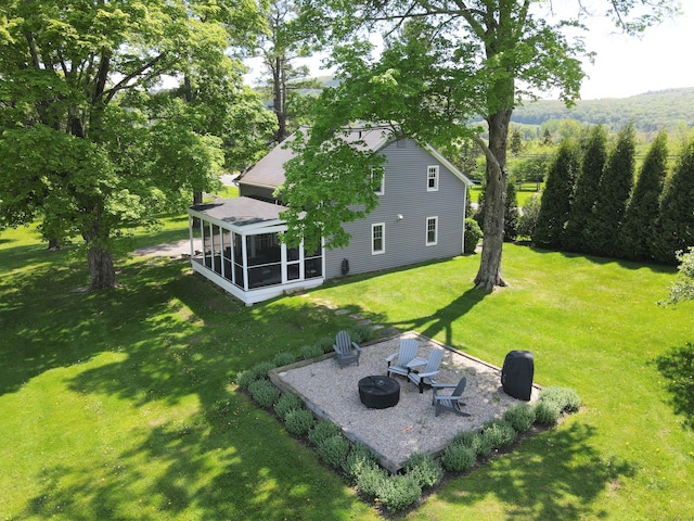 140 Lime Rock Rd, Salisbury, CT 06039 - view of grassy yard with a sunroom, an outdoor fire pit, and a patio