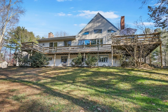 back of property featuring a yard and a wooden deck