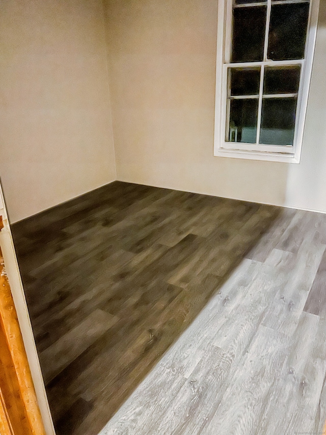 unfurnished room with hardwood / wood-style floors