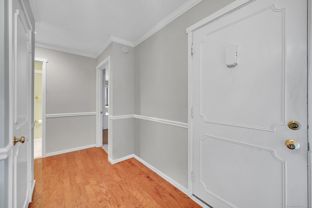 hallway with crown molding and light wood-type flooring