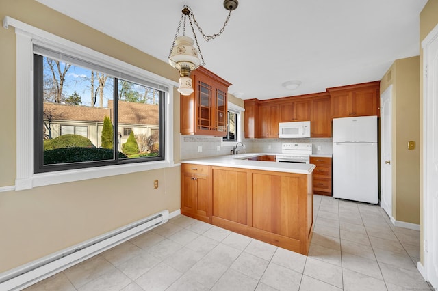 999 Heritage Vlg Unit B, Southbury, CT 06488 - kitchen featuring white appliances, baseboard heating, light countertops, and plenty of natural light