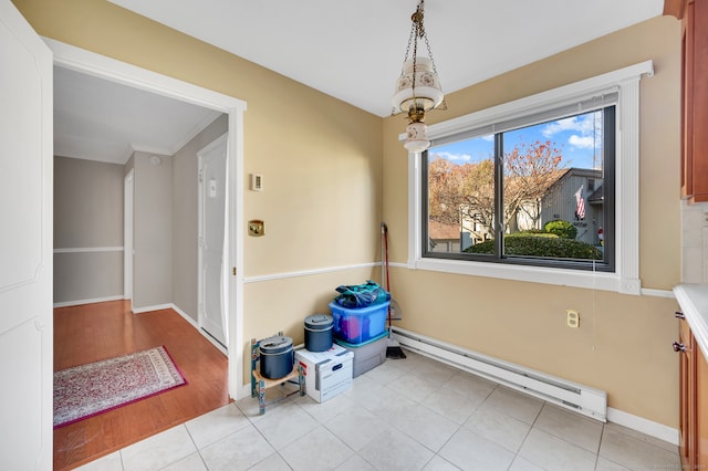 interior space featuring light hardwood / wood-style floors, crown molding, and baseboard heating