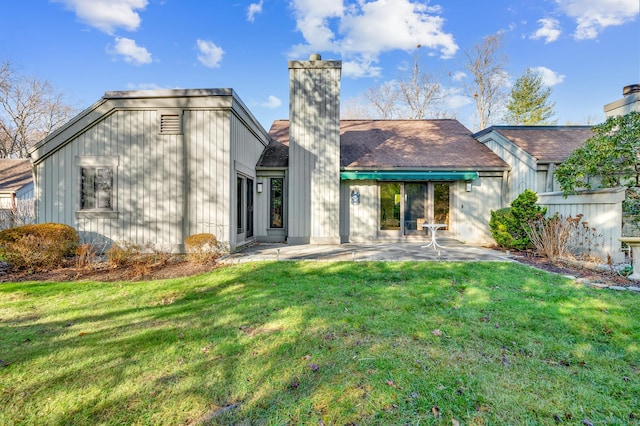 999 Heritage Vlg Unit B, Southbury, CT 06488 - rear view of property with a patio area, a chimney, and a lawn