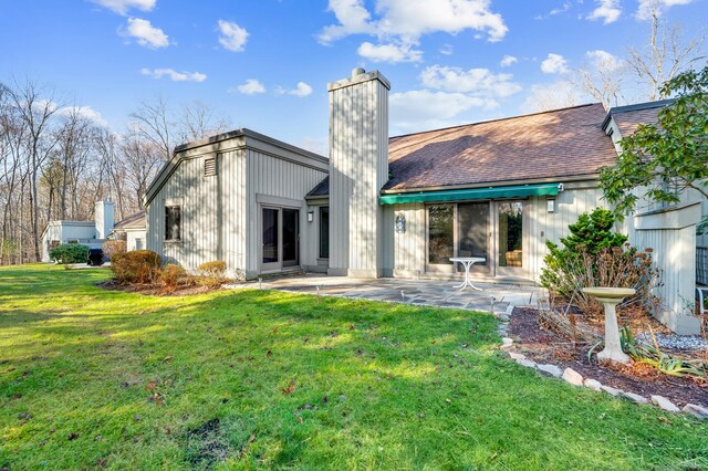 999 Heritage Vlg Unit B, Southbury, CT 06488 - back of house with a chimney, a patio area, and a yard