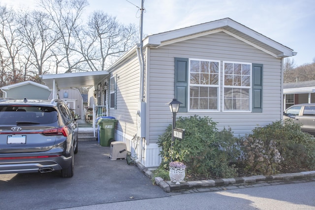 view of side of home with a carport