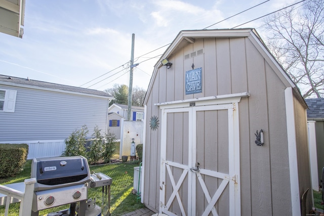 view of outbuilding with a yard