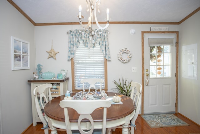 dining space featuring ornamental molding, a chandelier, hardwood / wood-style floors, and electric panel