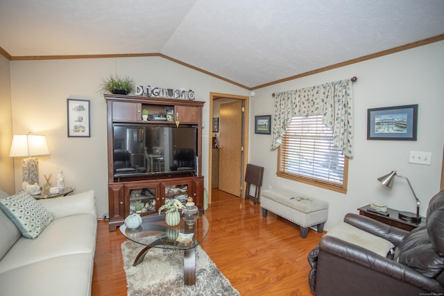 living room with hardwood / wood-style flooring, ornamental molding, and lofted ceiling