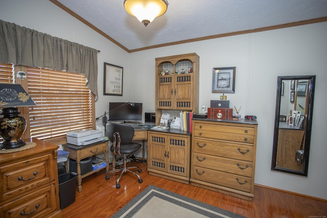 home office featuring hardwood / wood-style flooring, vaulted ceiling, ornamental molding, and a textured ceiling