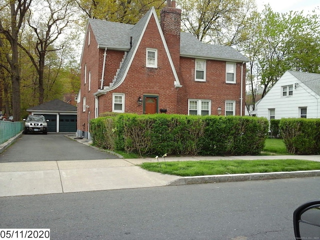 view of front of property featuring a garage and an outdoor structure