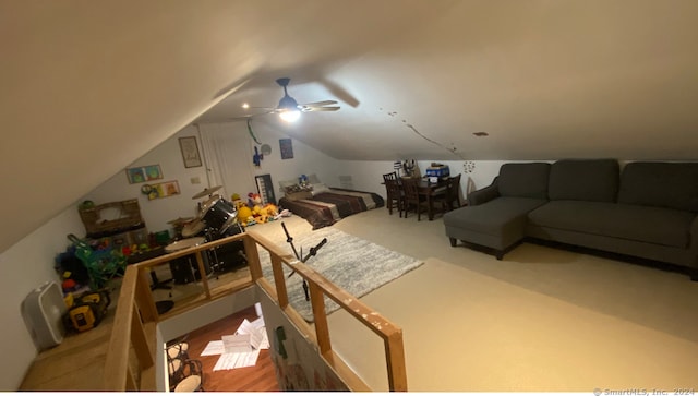 interior space with ceiling fan and vaulted ceiling