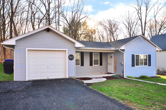 ranch-style home with a front lawn and a garage