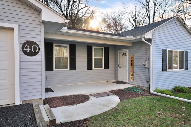 exterior entry at dusk featuring covered porch