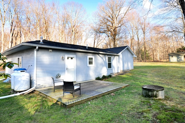 rear view of house with a yard and a deck