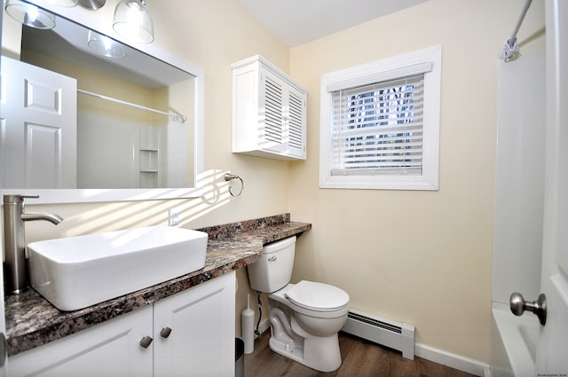 full bathroom featuring vanity, baseboard heating, shower / bathing tub combination, hardwood / wood-style flooring, and toilet