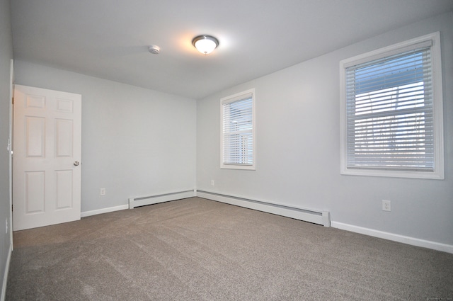 carpeted empty room with a wealth of natural light and a baseboard radiator