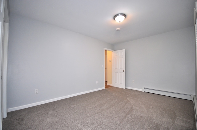 carpeted spare room with baseboard heating