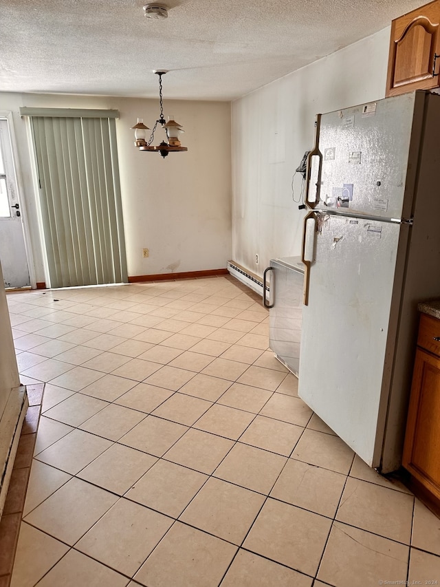 interior space with a textured ceiling, light tile patterned floors, baseboard heating, and an inviting chandelier