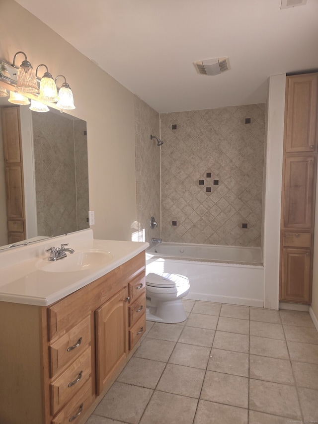 full bathroom with tile patterned flooring, vanity, tiled shower / bath combo, and toilet