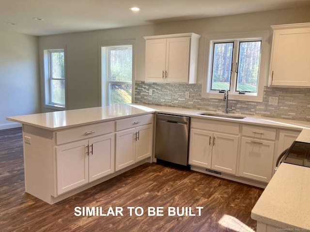 kitchen with dishwasher, dark hardwood / wood-style floors, white cabinets, and sink