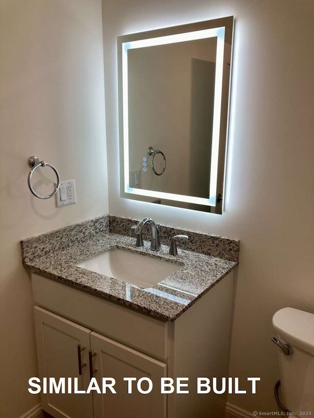 bathroom with vanity and toilet