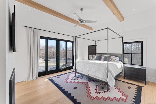 bedroom featuring ceiling fan, beam ceiling, access to outside, and multiple windows