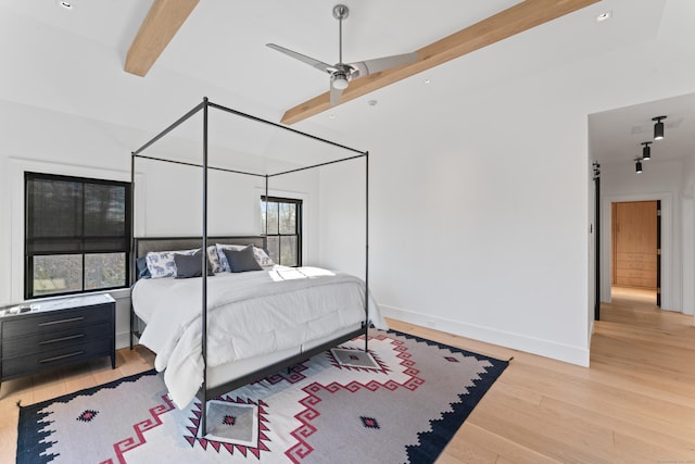 bedroom featuring beam ceiling, ceiling fan, and light hardwood / wood-style floors