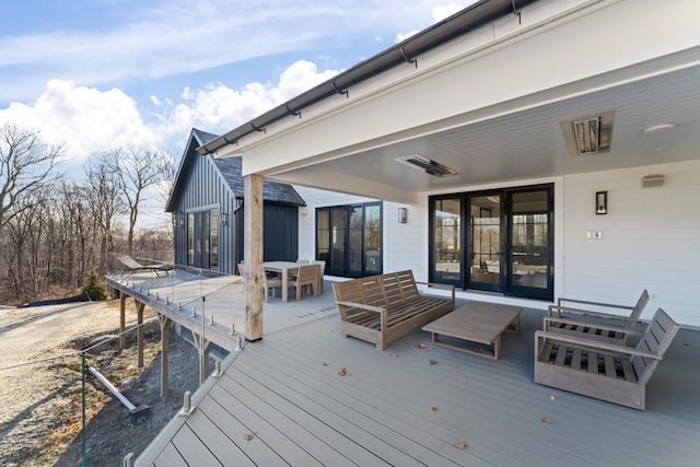 wooden deck featuring outdoor lounge area