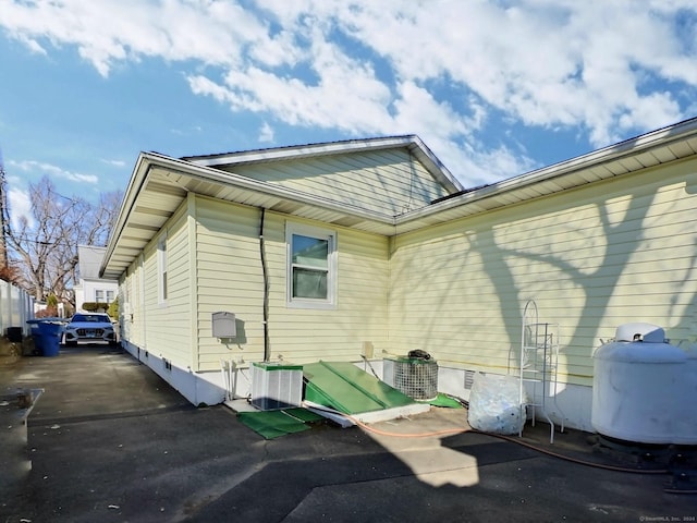 view of side of property with central AC unit