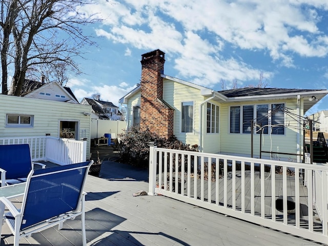 rear view of house with a wooden deck