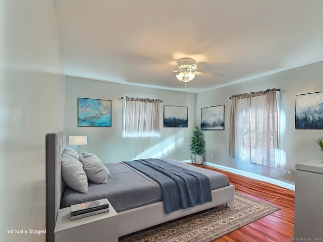 bedroom featuring ceiling fan and wood-type flooring