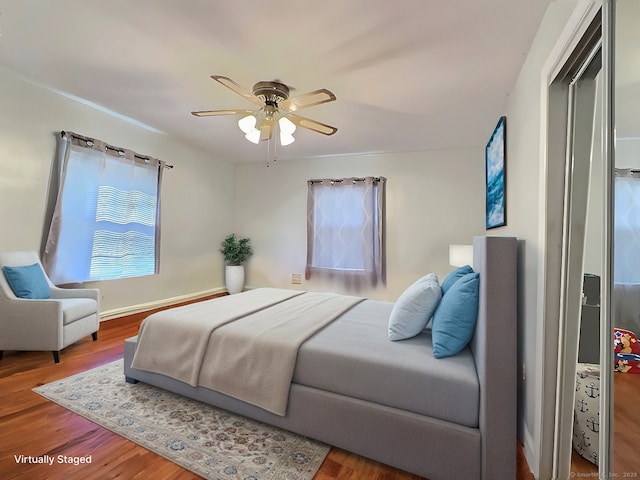 bedroom featuring wood-type flooring and ceiling fan