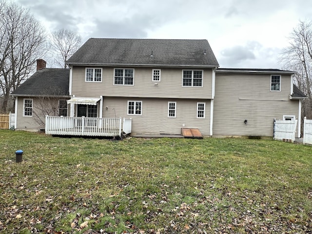 back of house with a yard and a deck