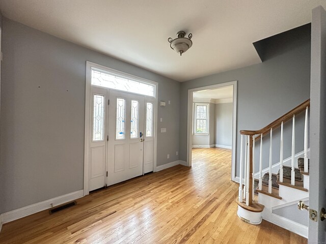 foyer entrance with light hardwood / wood-style flooring