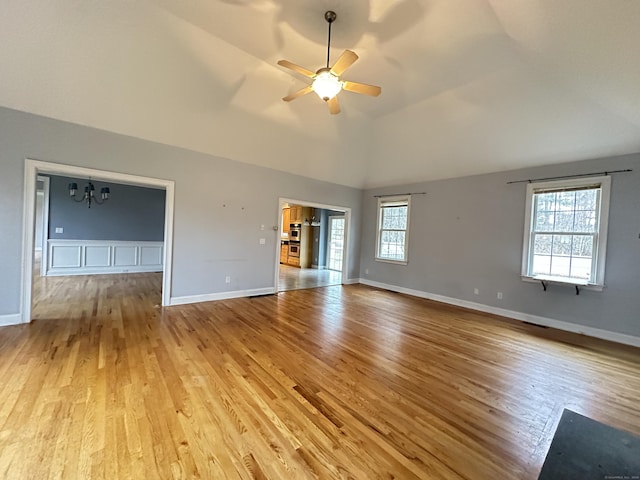 interior space featuring light hardwood / wood-style flooring, a wealth of natural light, lofted ceiling, and ceiling fan