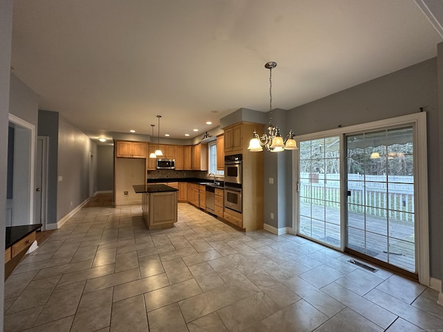 kitchen with pendant lighting, decorative backsplash, a kitchen island, stainless steel appliances, and a chandelier