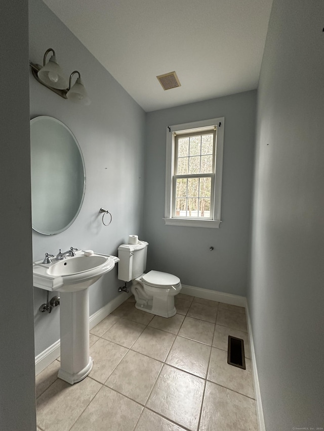 bathroom featuring tile patterned floors and toilet