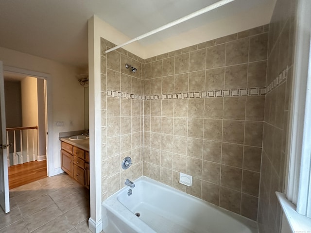 bathroom featuring tile patterned floors, vanity, and tiled shower / bath combo