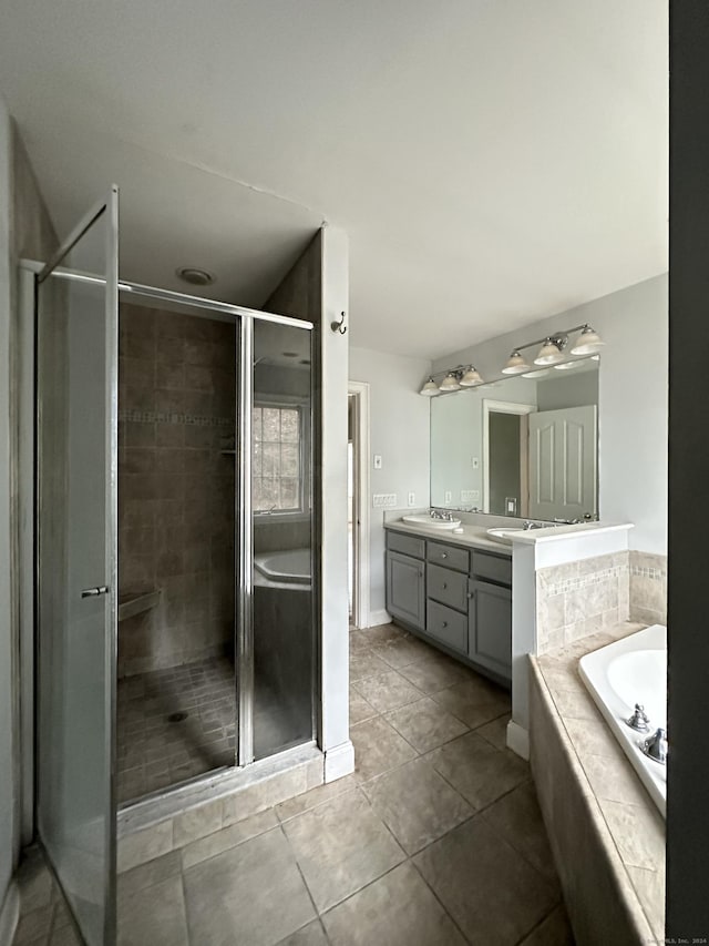 bathroom featuring tile patterned flooring, vanity, and separate shower and tub