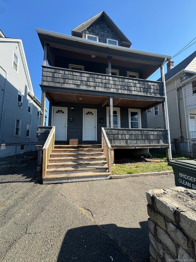 view of front of property featuring a porch and a balcony