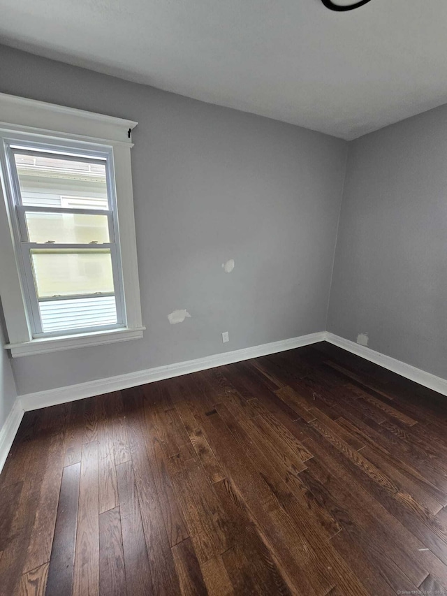 unfurnished room featuring dark hardwood / wood-style floors