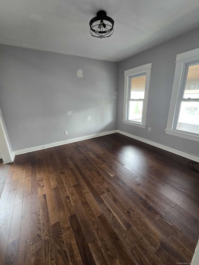 empty room with dark wood-type flooring