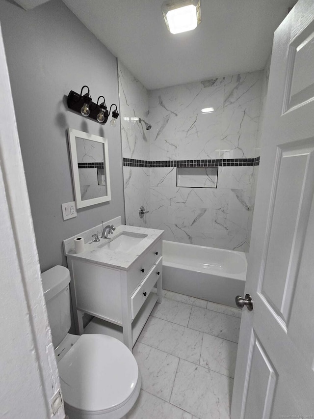 full bathroom featuring toilet, vanity, and tiled shower / bath