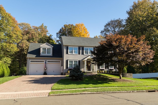 view of front of property with a garage and a front yard